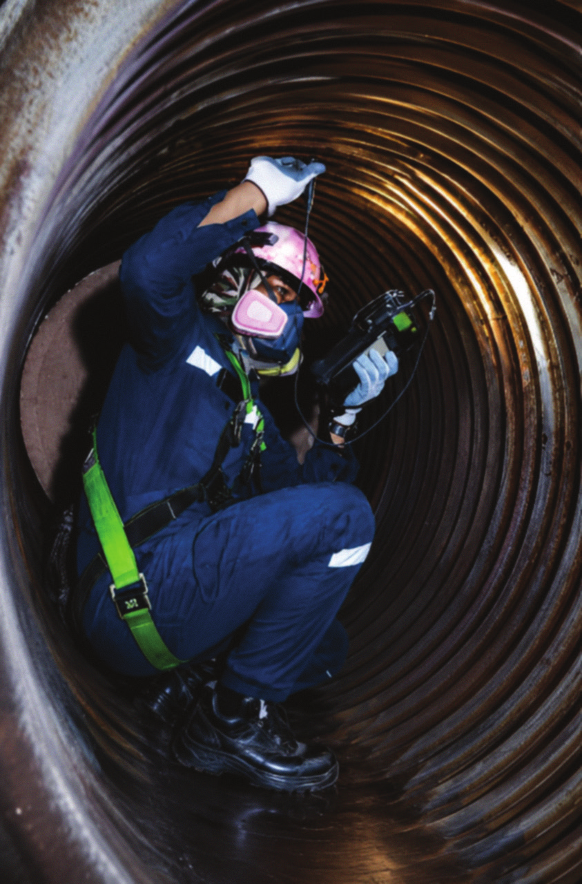 Engineer inspecting boiler interior